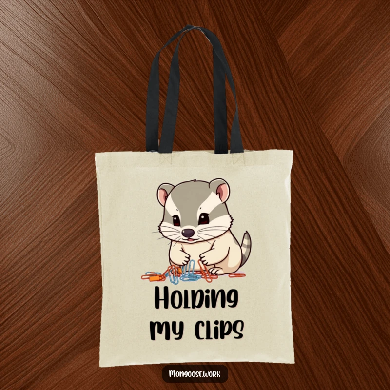 Funny mongoose tote bag, a focused mongoose organizing paperclips with its nose, office organization humor.
